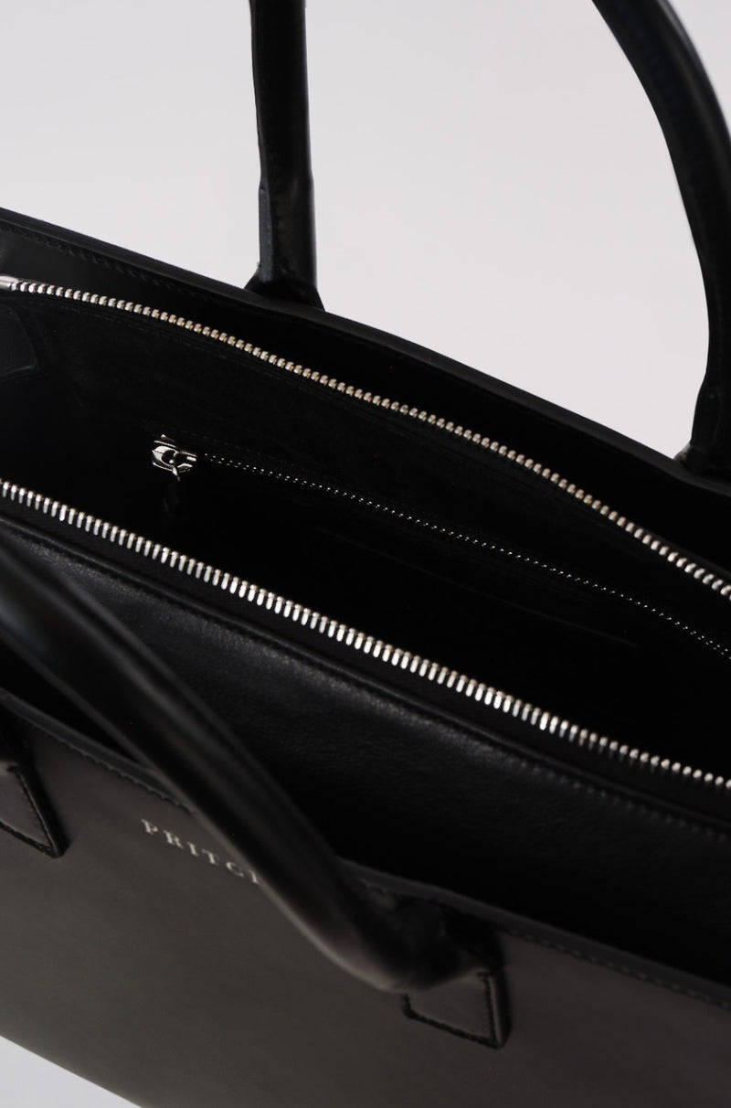 black leather tote bag close up of zip