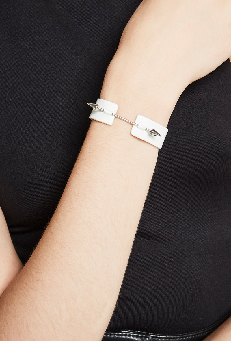 white leather bracelet with piercing metal bar